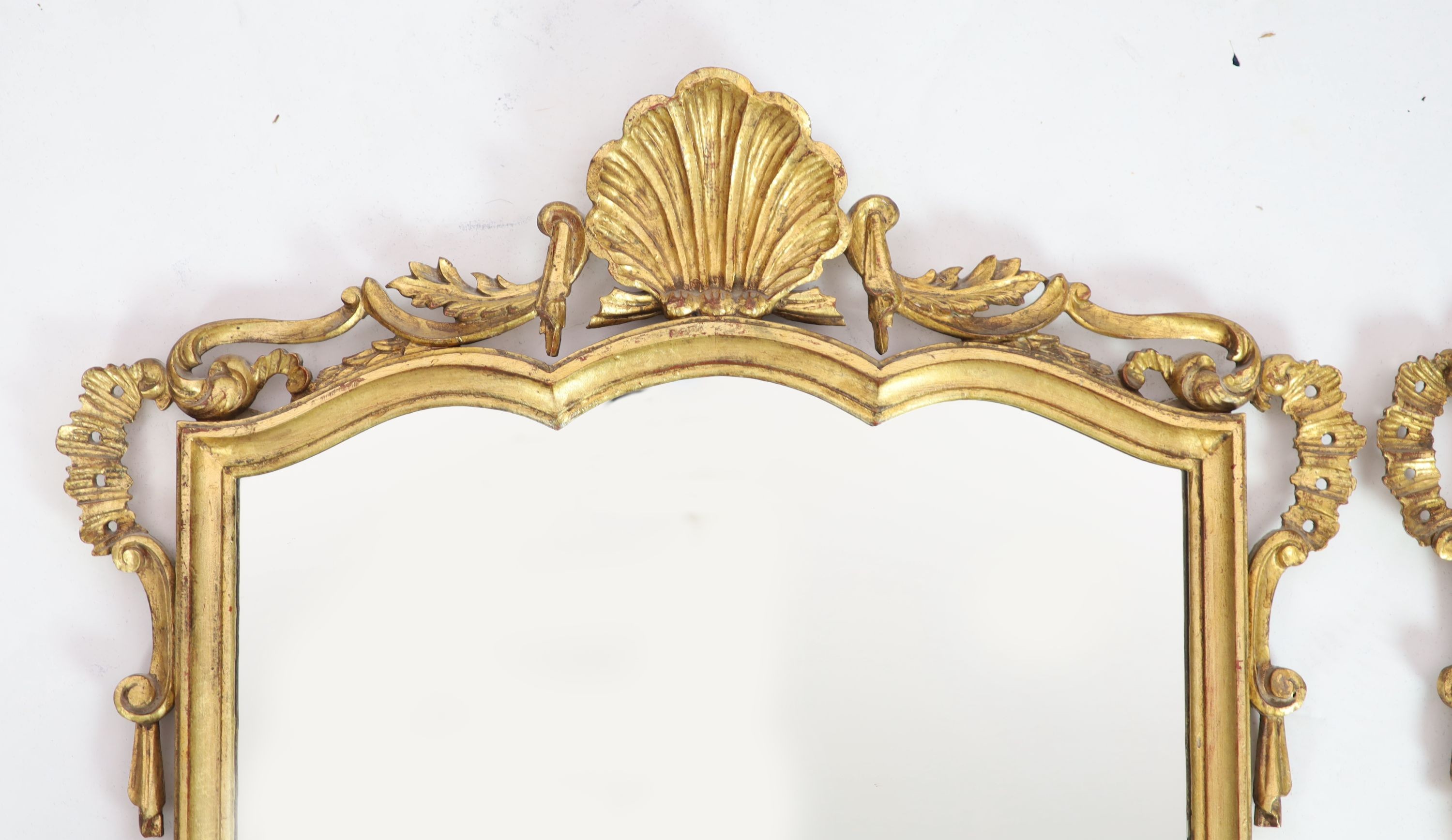 A pair of Georgian style carved giltwood wall mirrors